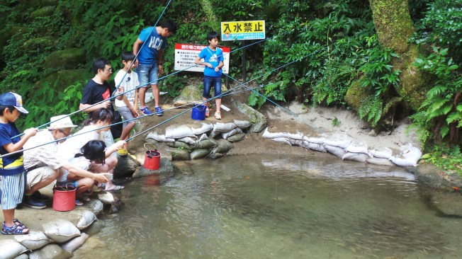 On pêche son poisson à la cascade Shiraito, Itoshima, Kyushu, Japon